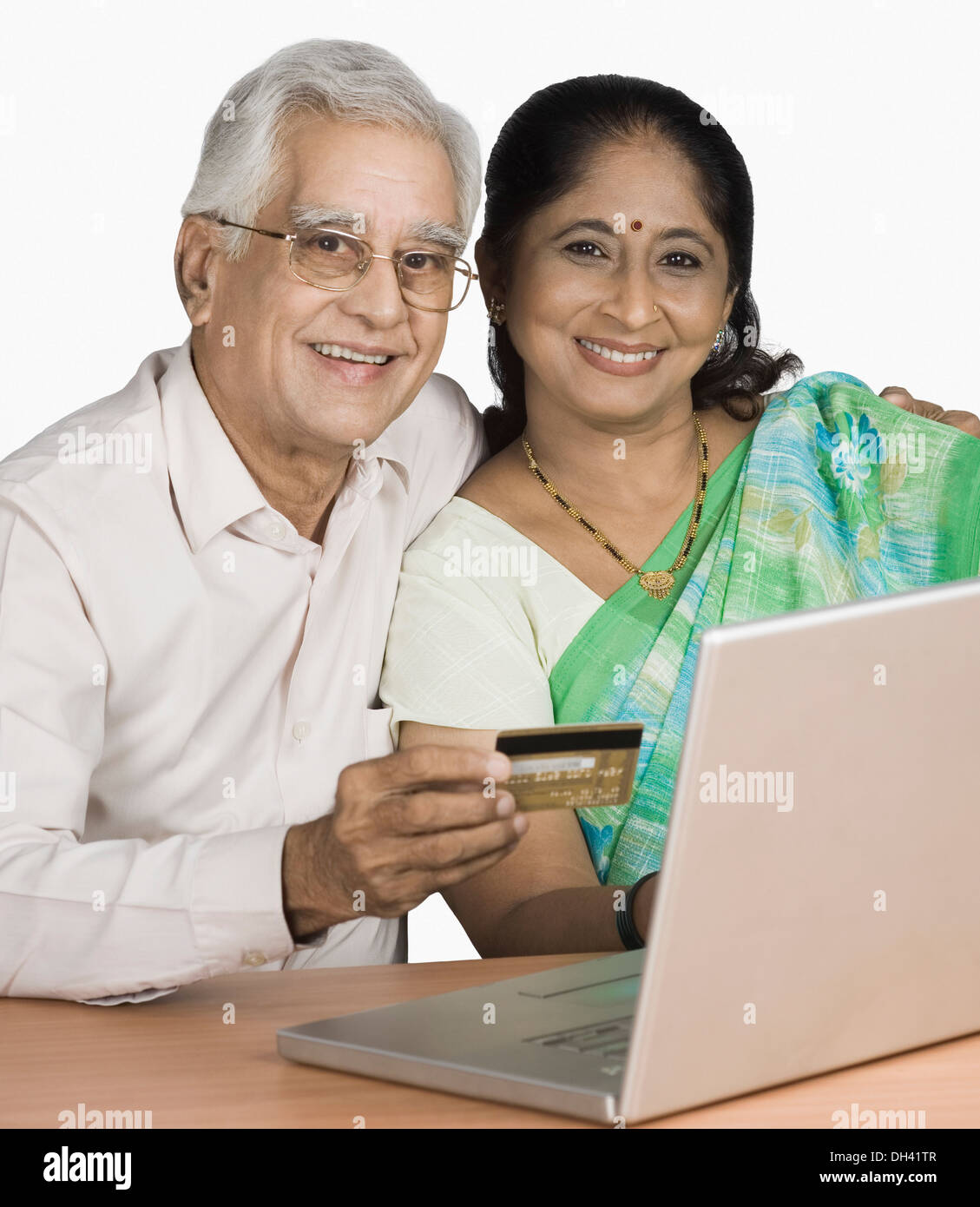 Senior man and a mature woman shopping online Stock Photo