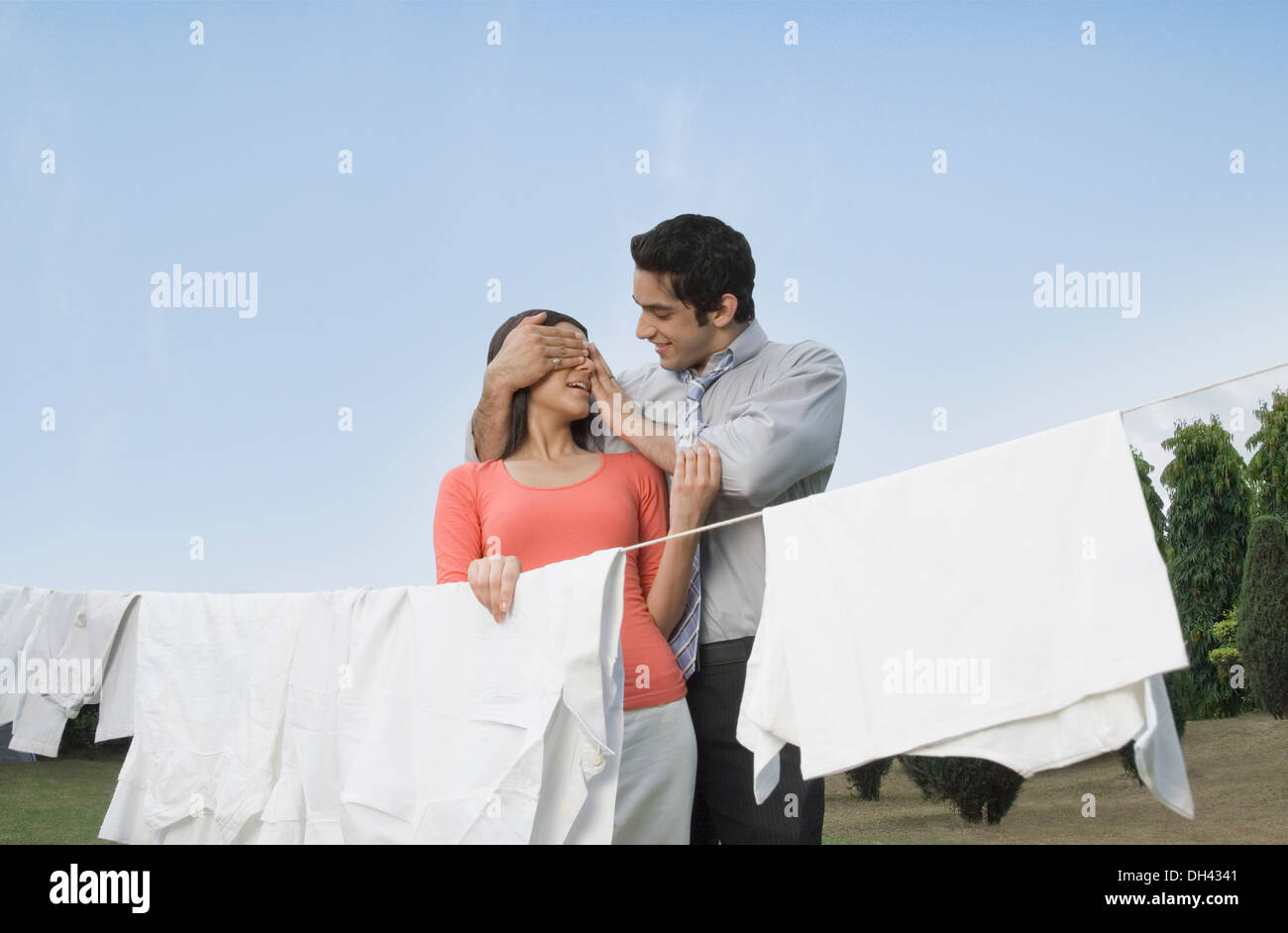 Man covering woman's eyes and smiling Stock Photo