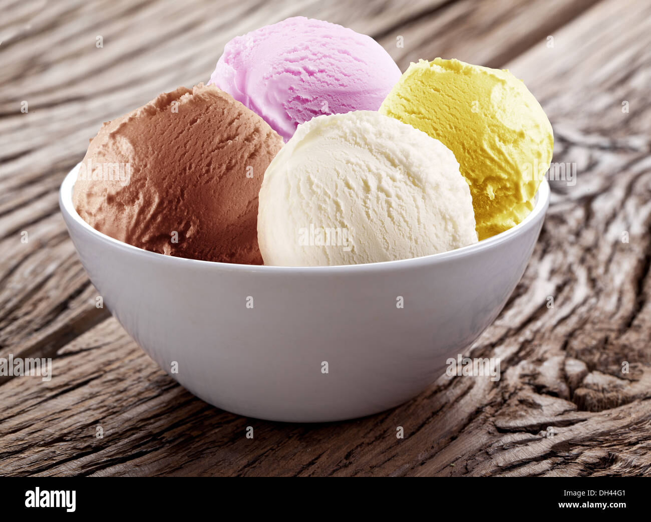 Icecream scoops in white cup on a wooden background Stock Photo Alamy