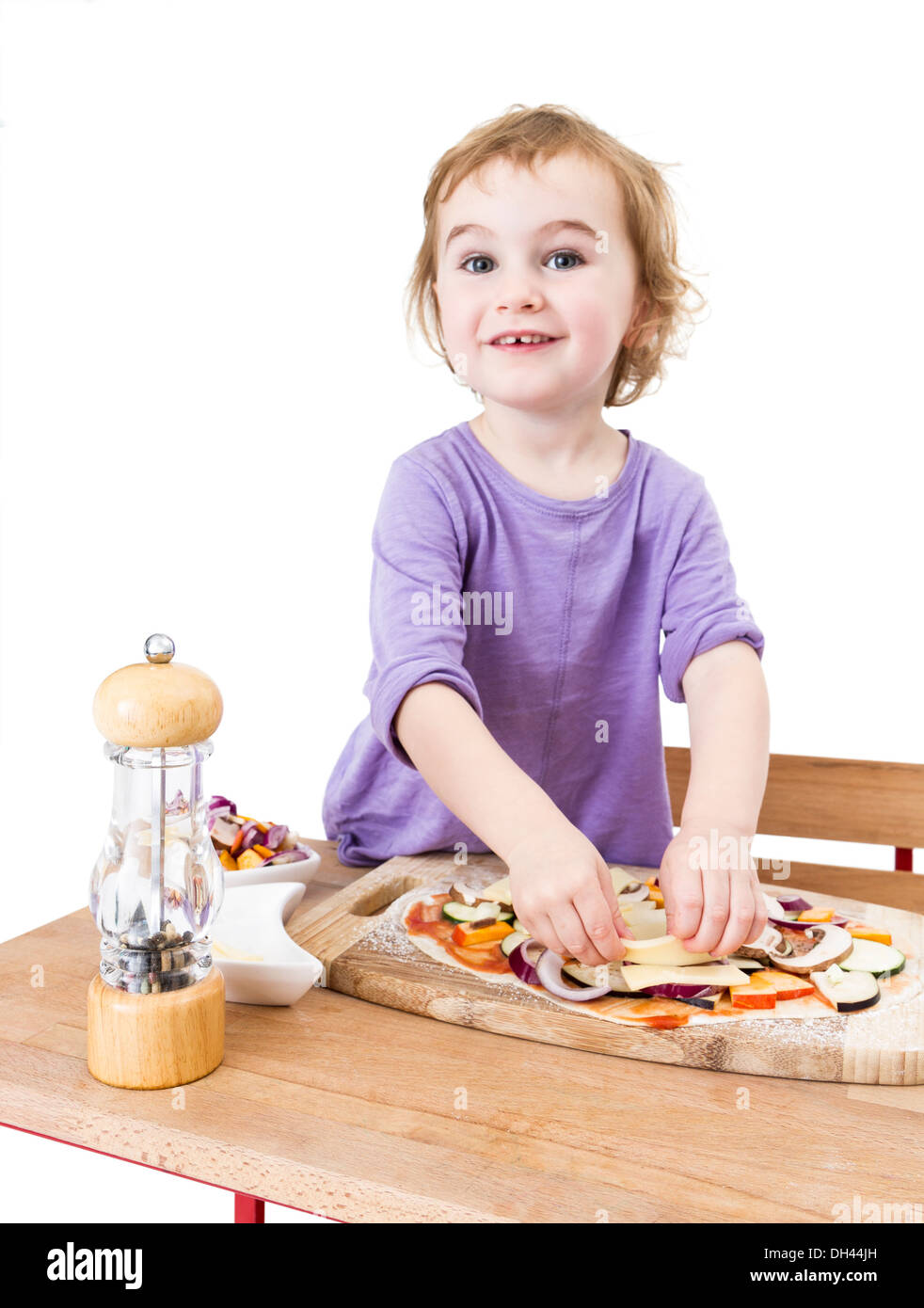 cute girl making pizza with a smile. isolated on white background Stock Photo
