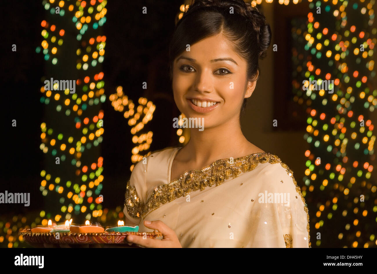 Woman holding religious offering and smiling Stock Photo