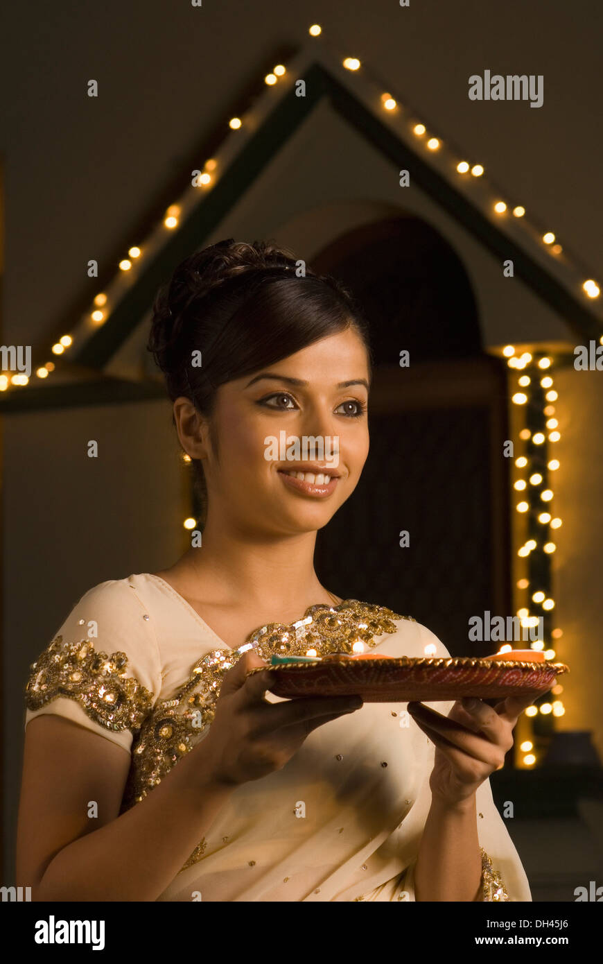 Woman holding religious offering and smiling Stock Photo