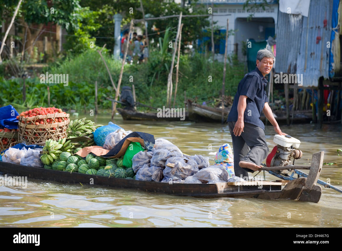 men rowing in a boat in a floating market. Mekong delta, Vietnam, Asia ...