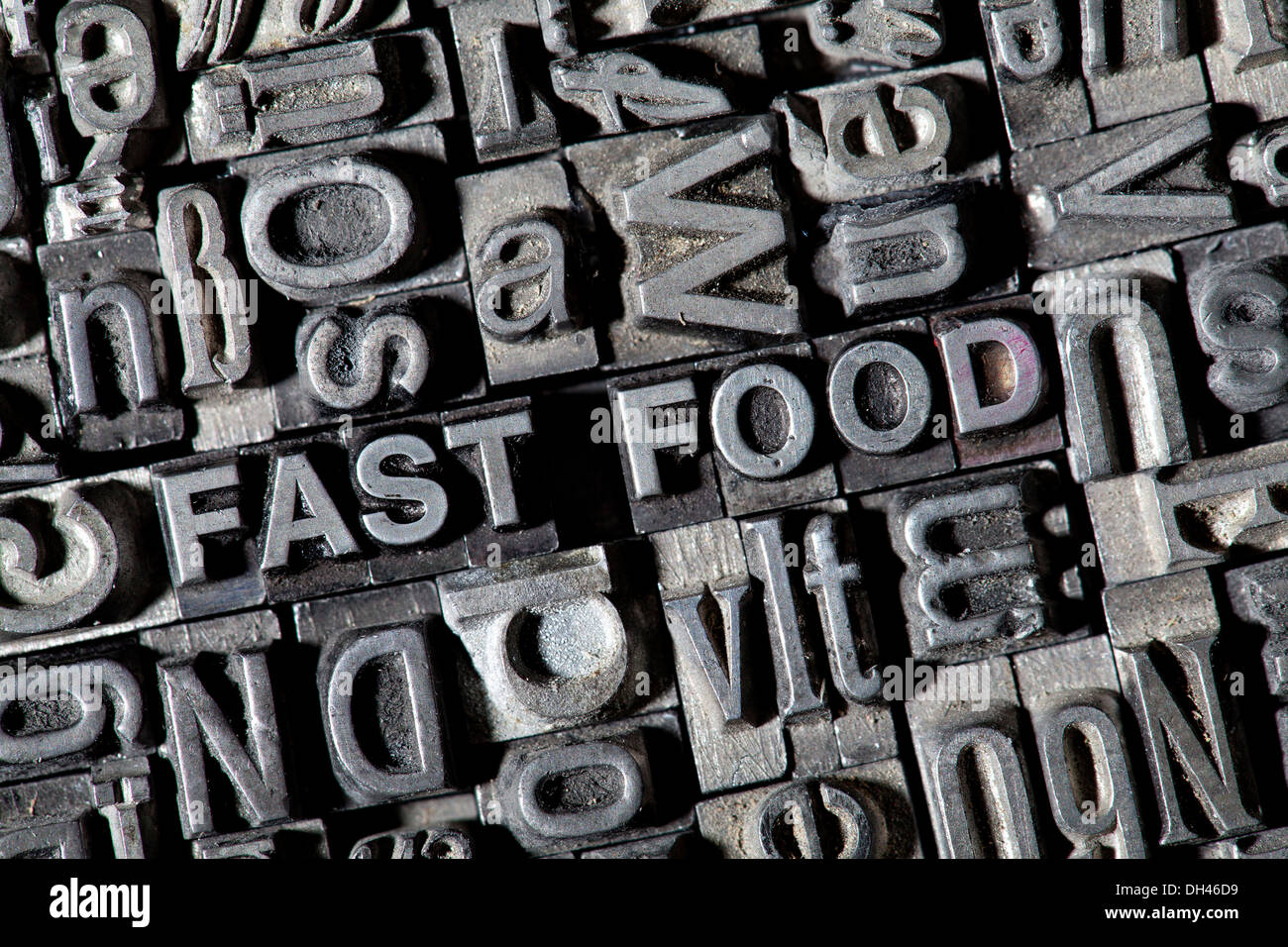 Old lead letters forming the term FAST FOOD Stock Photo
