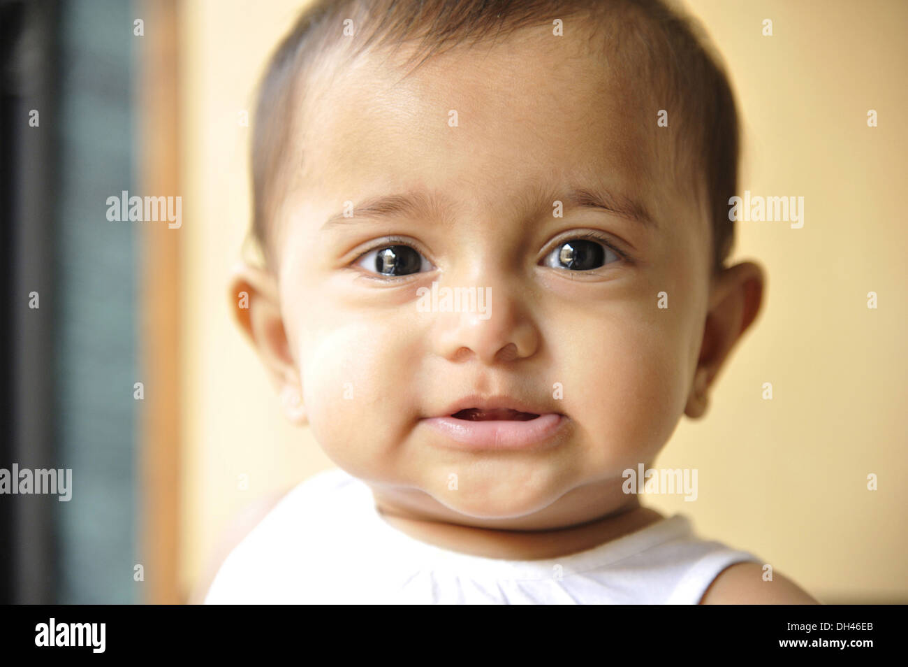 Indian baby face portrait closeup looking at camera eye contact India    MR#736LA Stock Photo
