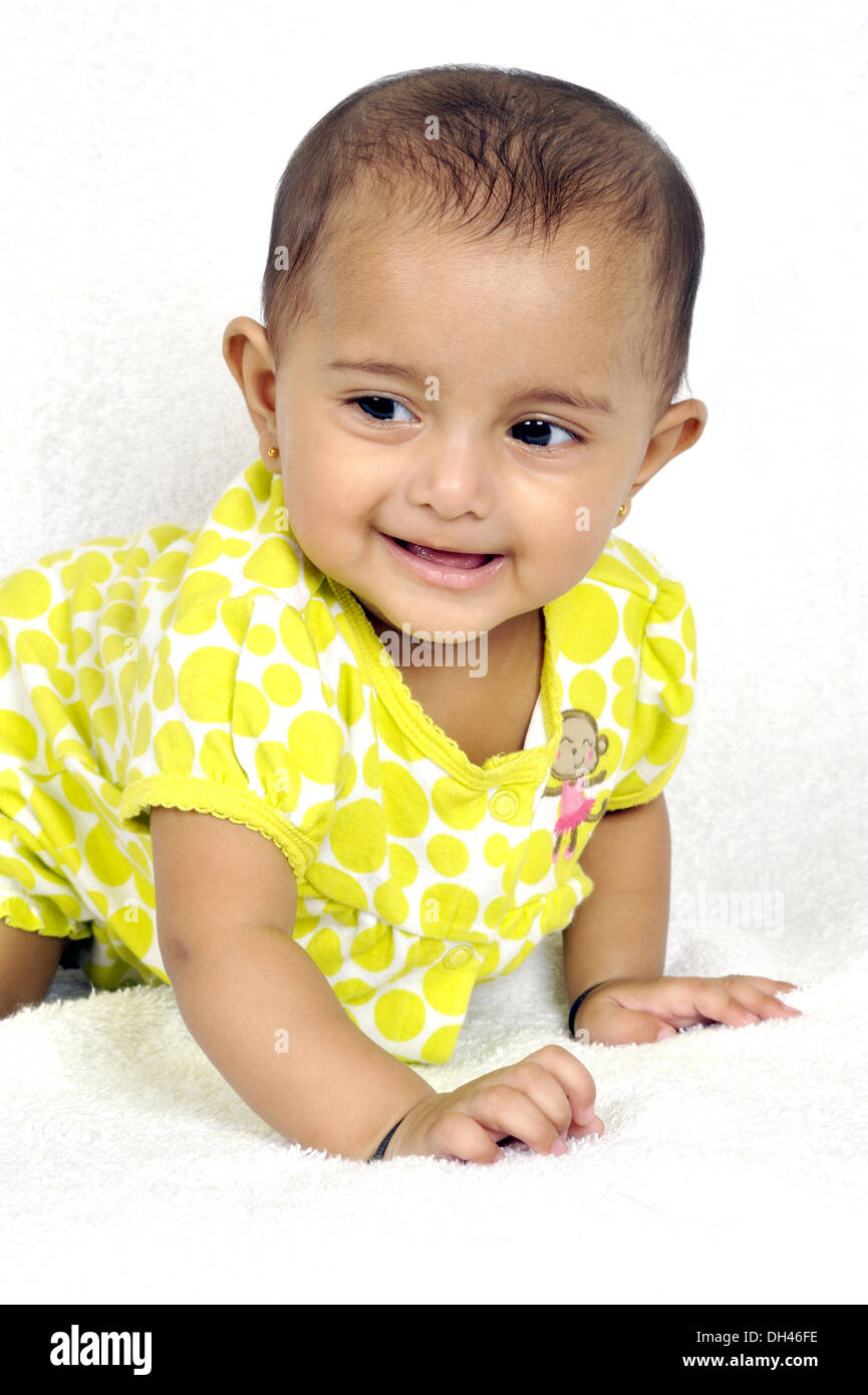 baby in yellow dress crawling on white background MR 736LA Stock Photo Alamy
