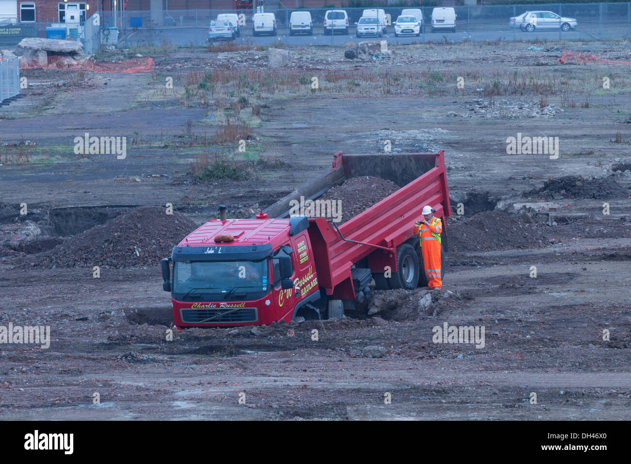 Lorry, truck stuck in sinkhole on demolition/ building site. UK Stock Photo