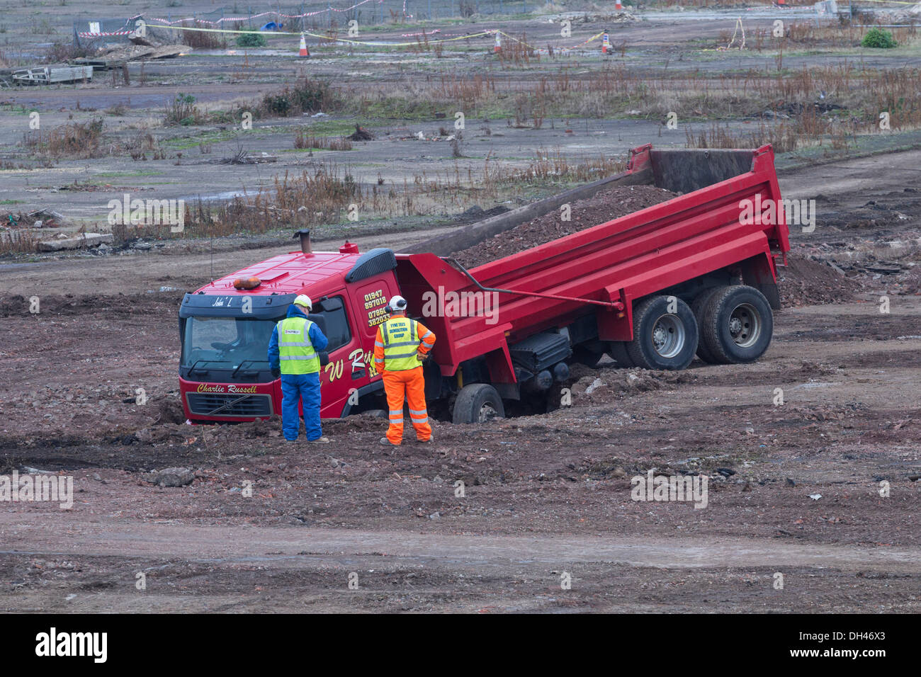 Lorry, truck stuck in sinkhole on demolition/ building site. UK Stock Photo