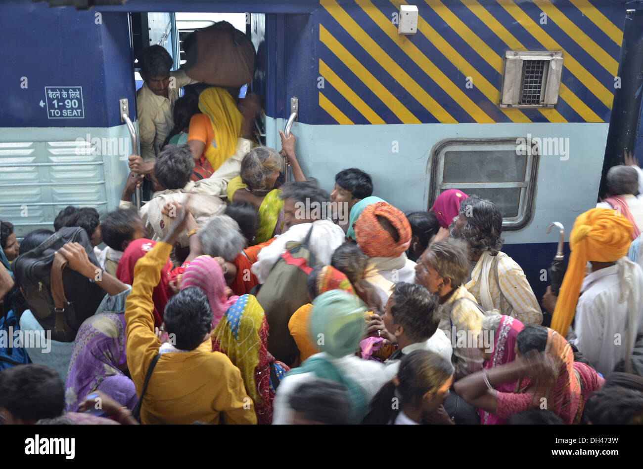 People crowded rushing trying to enter train bogie compartment at Jodhpur Rajasthan India Asia Stock Photo