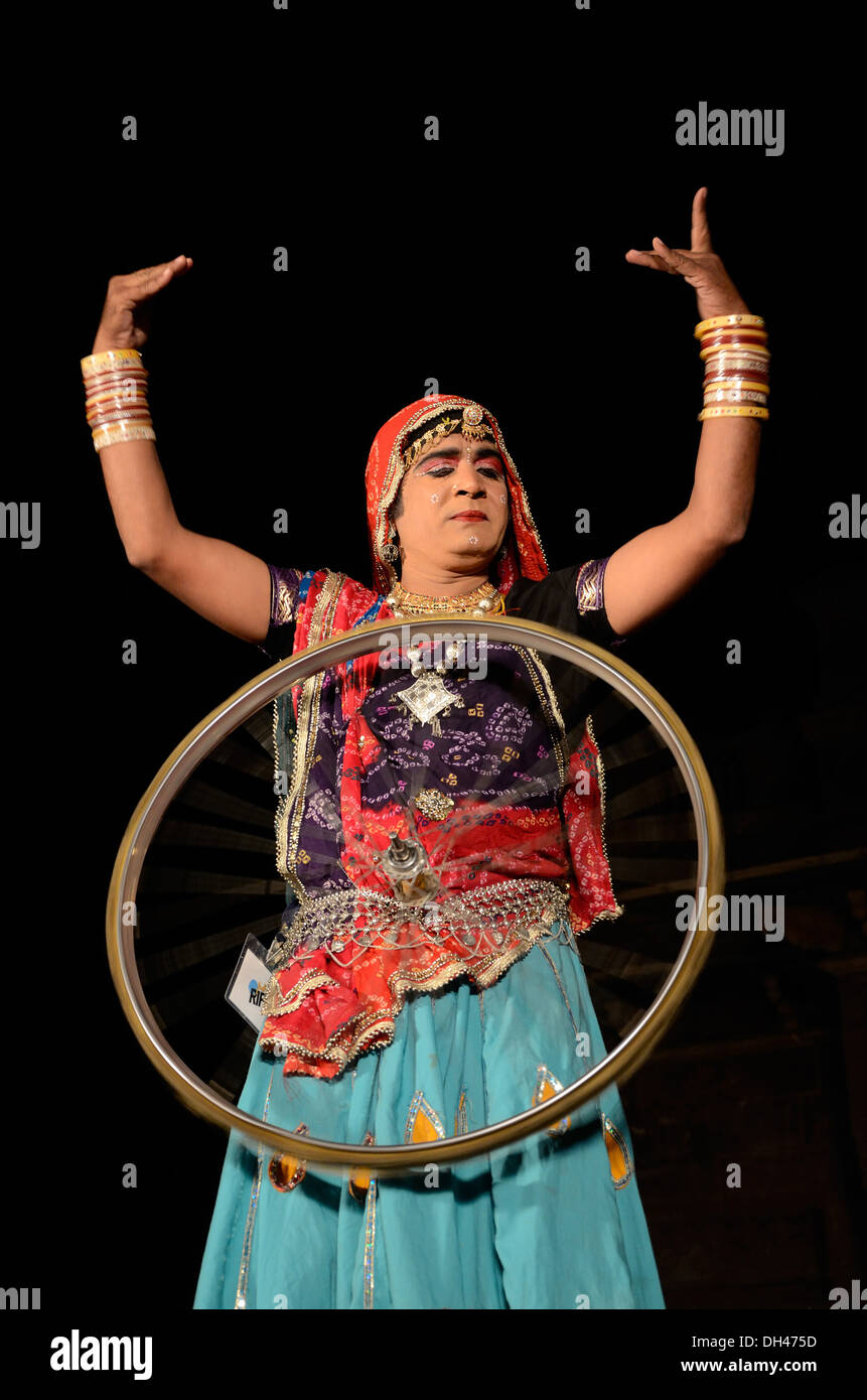 man dressed as woman performing acrobatics in Marwar Festival Jodhpur Rajasthan India Stock Photo