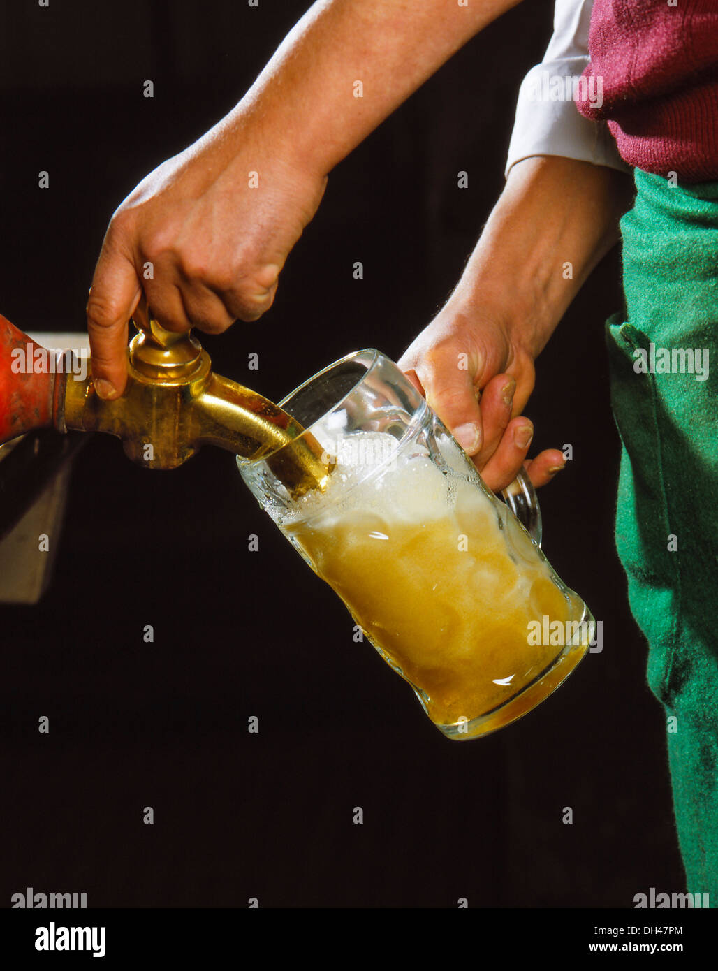 A liter of beer is tapped from a wooden barrel Stock Photo Alamy