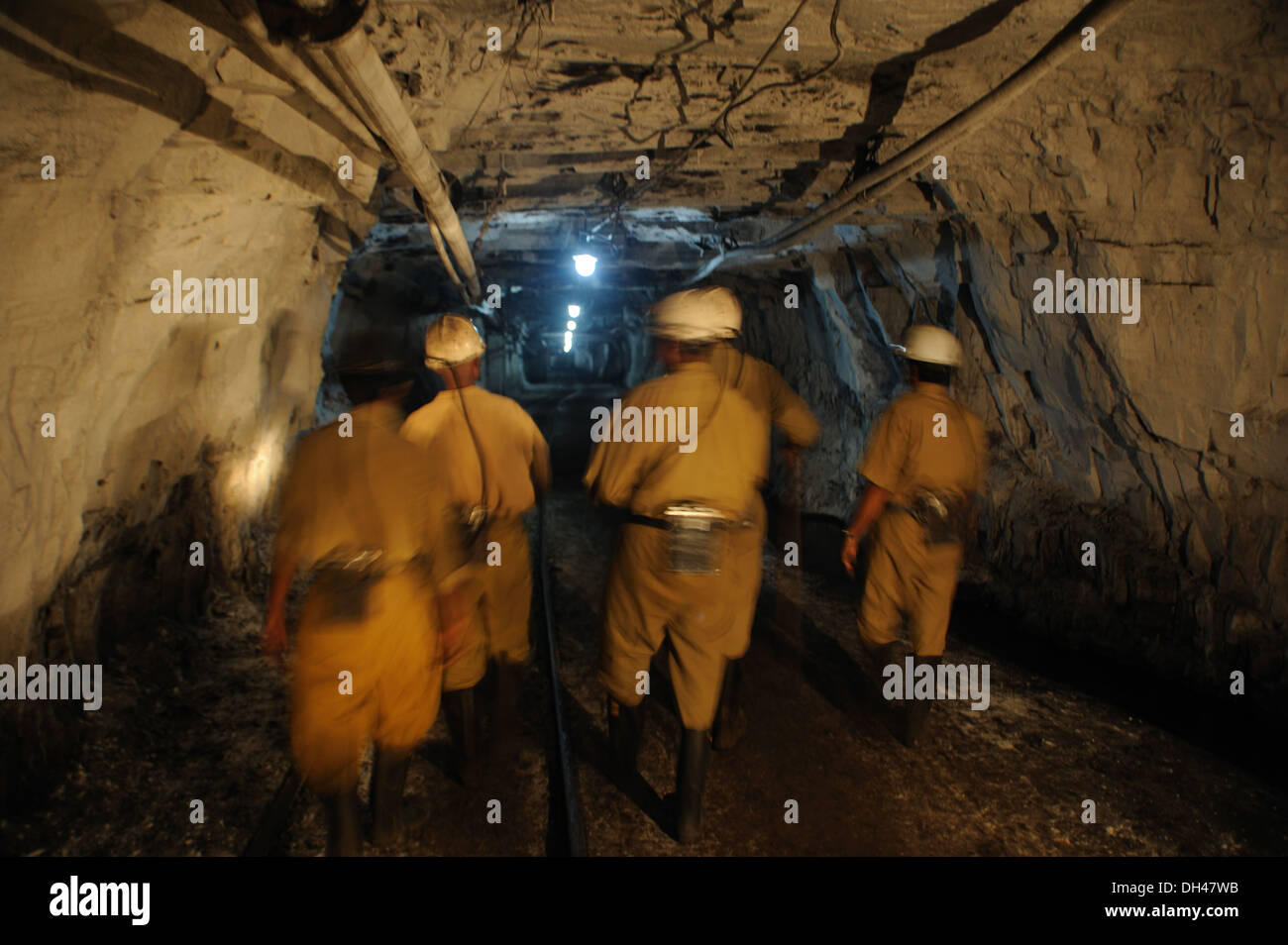 miners are walking through the tunnel at the underground coal mine in jharkhand India Stock Photo