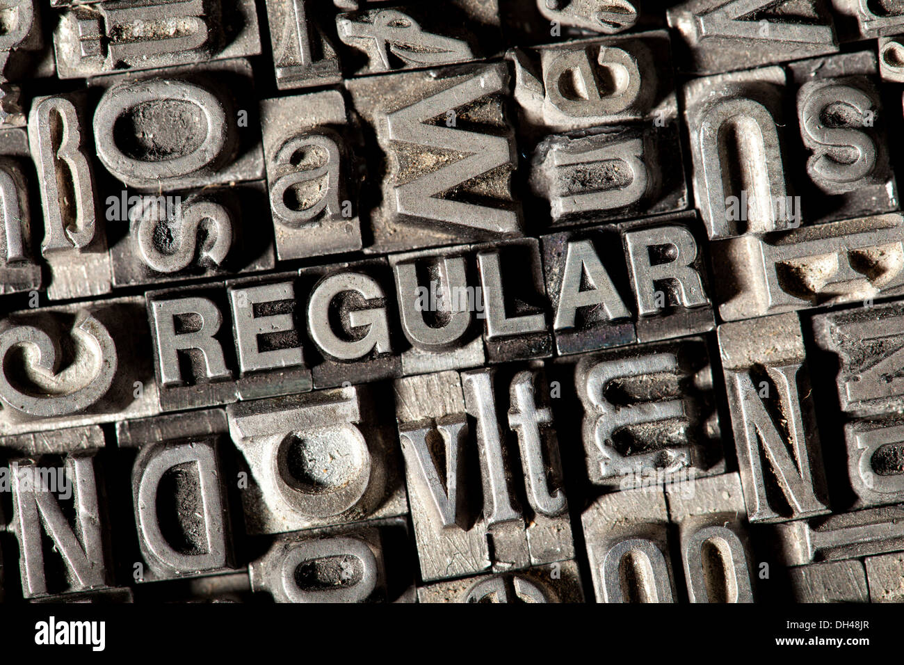 Old lead letters forming the word 'REGULAR' Stock Photo
