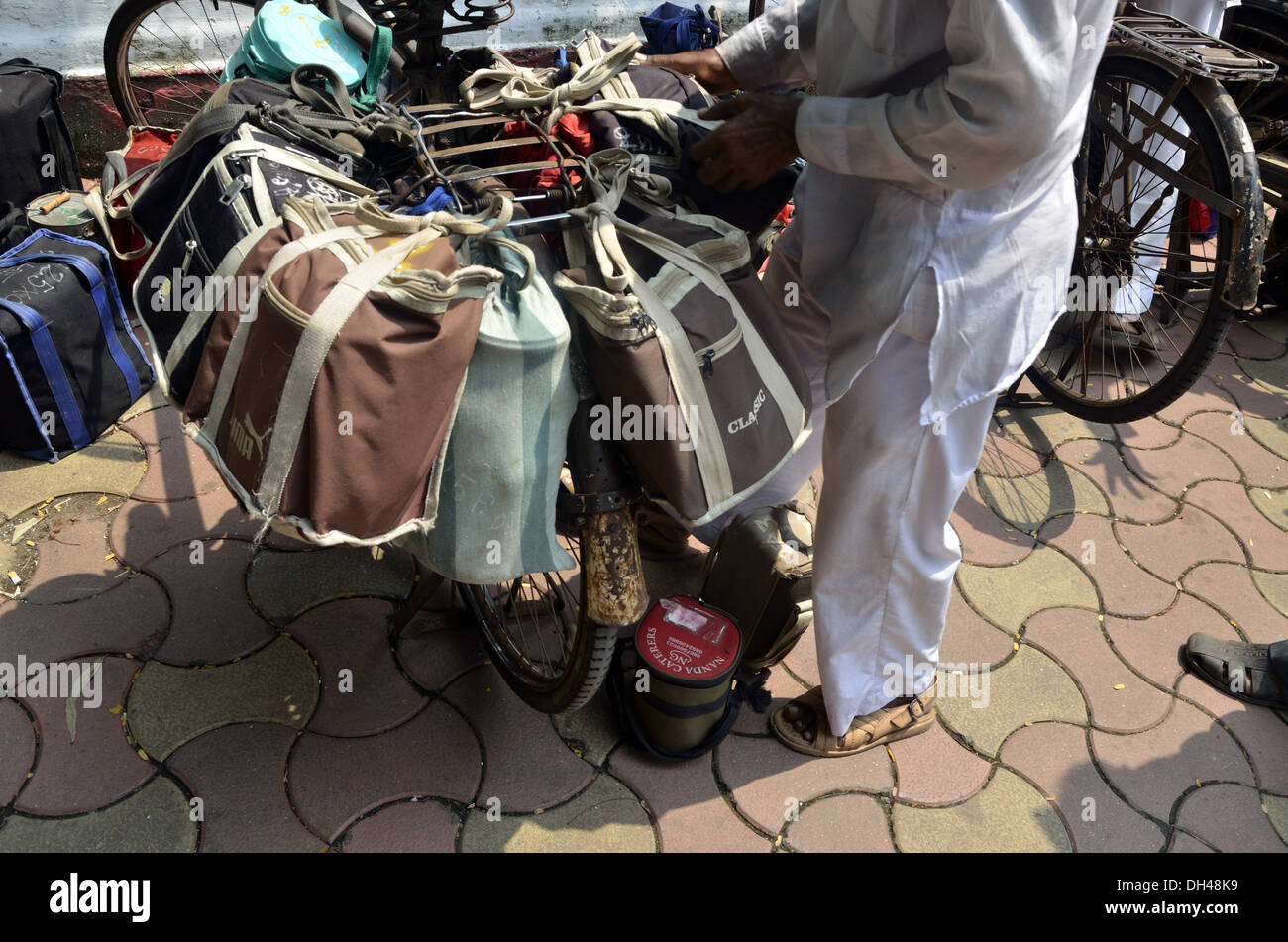 dabbawalas carrying lunchbox on cycle at mumbai maharashtra India Stock Photo