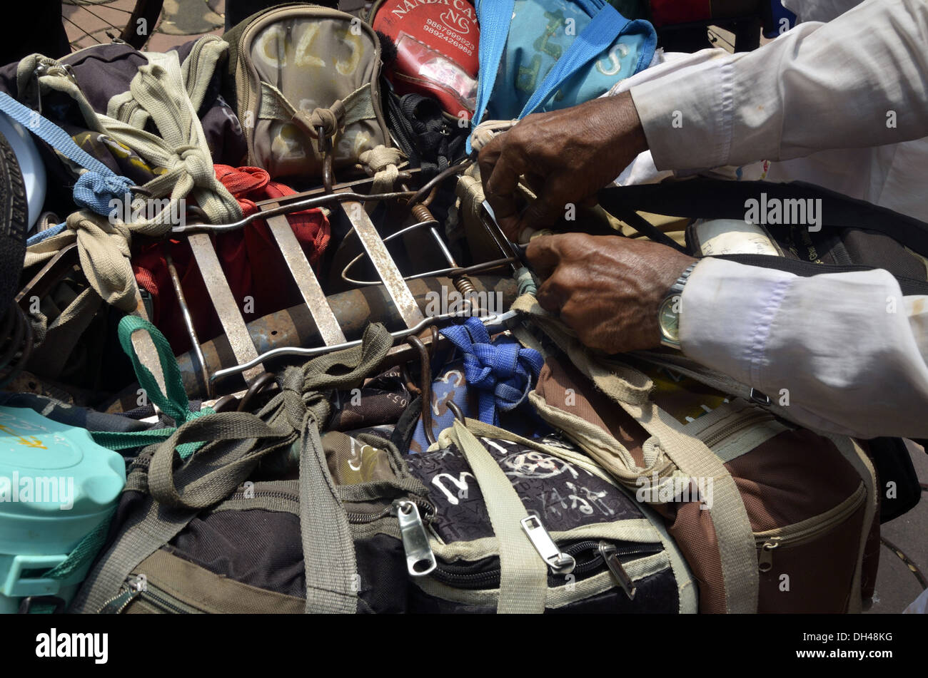 Lunchboxes tied on cycle at mumbai maharashtra India Stock Photo