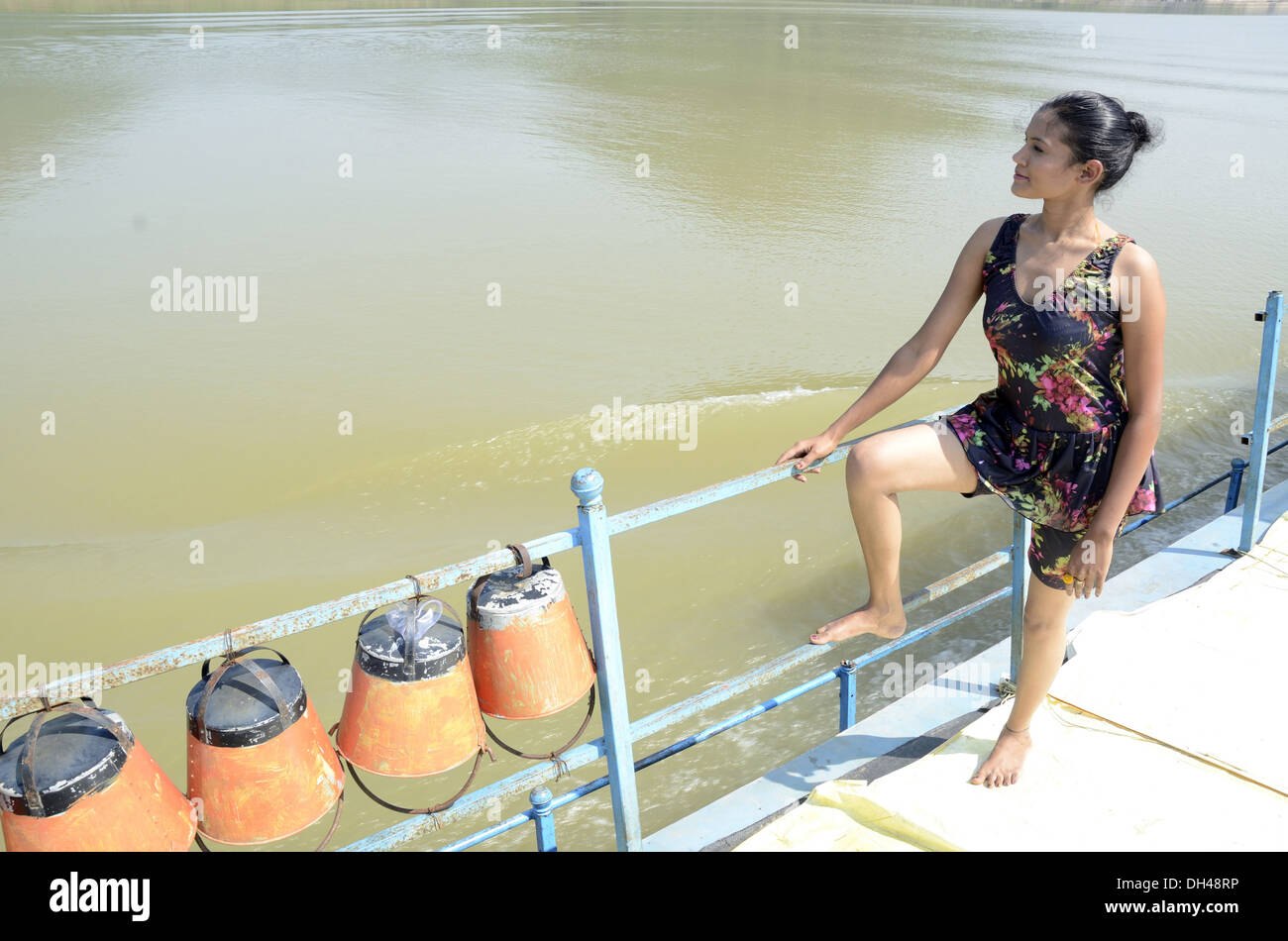 girl in swimsuit on a boat at Rajahmundry Andhra Pradesh India   MR#704K Stock Photo
