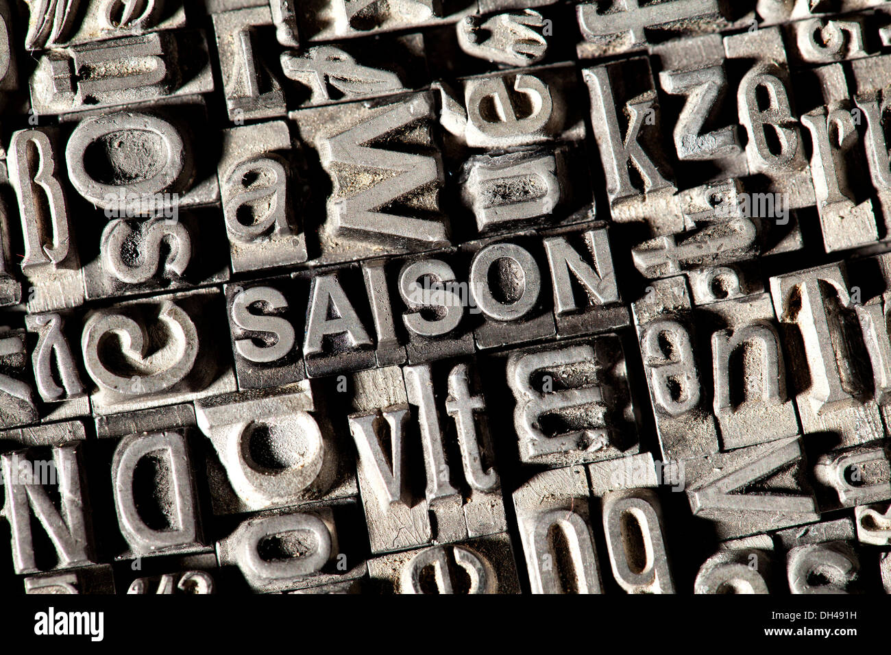 Old lead letters forming the word SAISON, German for season Stock Photo
