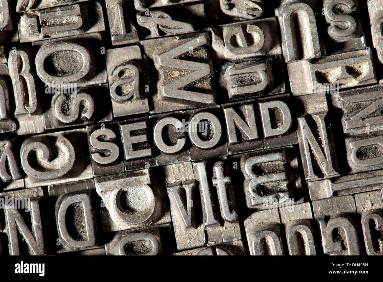 Old lead letters forming the word SECOND Stock Photo