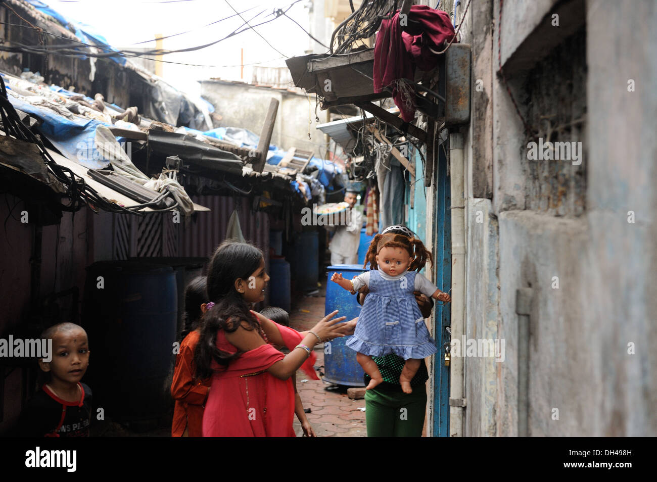 children playing with doll in slum of Bachuwadi Kamathipura Mumbai India Asia Stock Photo