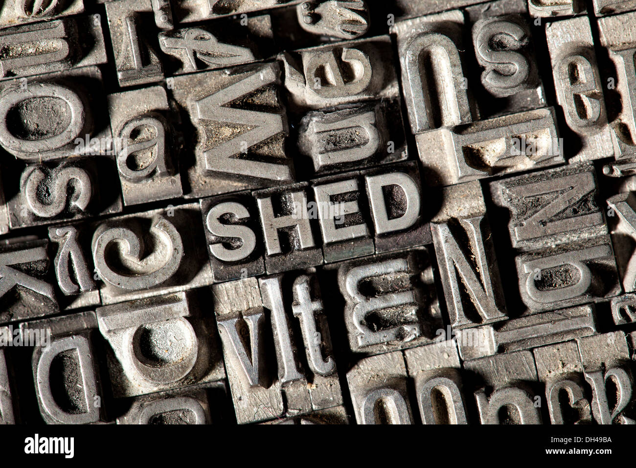 Old lead letters forming the word SHED Stock Photo