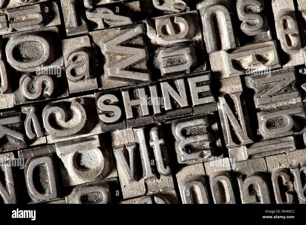 Old lead letters forming the word SHINE Stock Photo