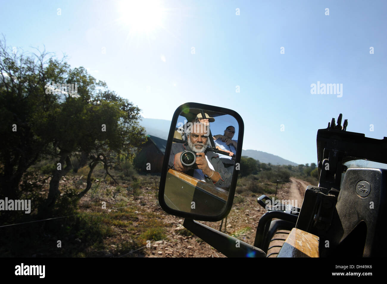 photographer seen in rear view jeep mirror south africa   model released Stock Photo