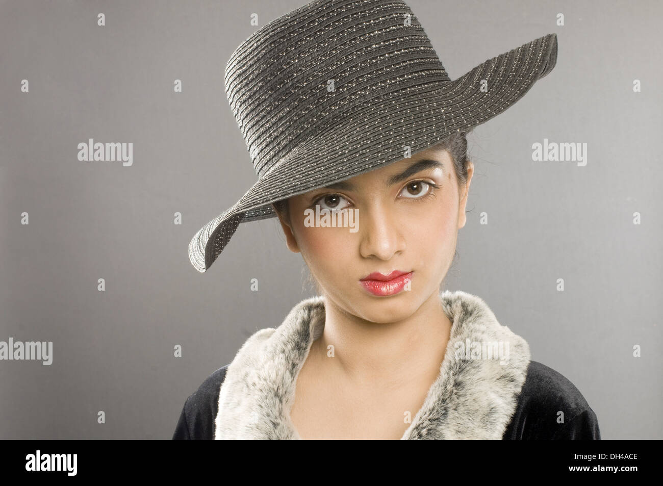 woman in fur collar coat and hat Pune Maharashtra India Asia MR#191 April 2012 Stock Photo