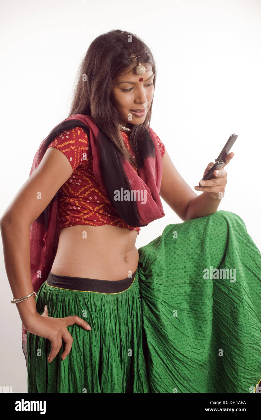 Girl wearing traditional dress with mobile phone Pune Maharashtra India Asia MR#686Z June 2012 Stock Photo
