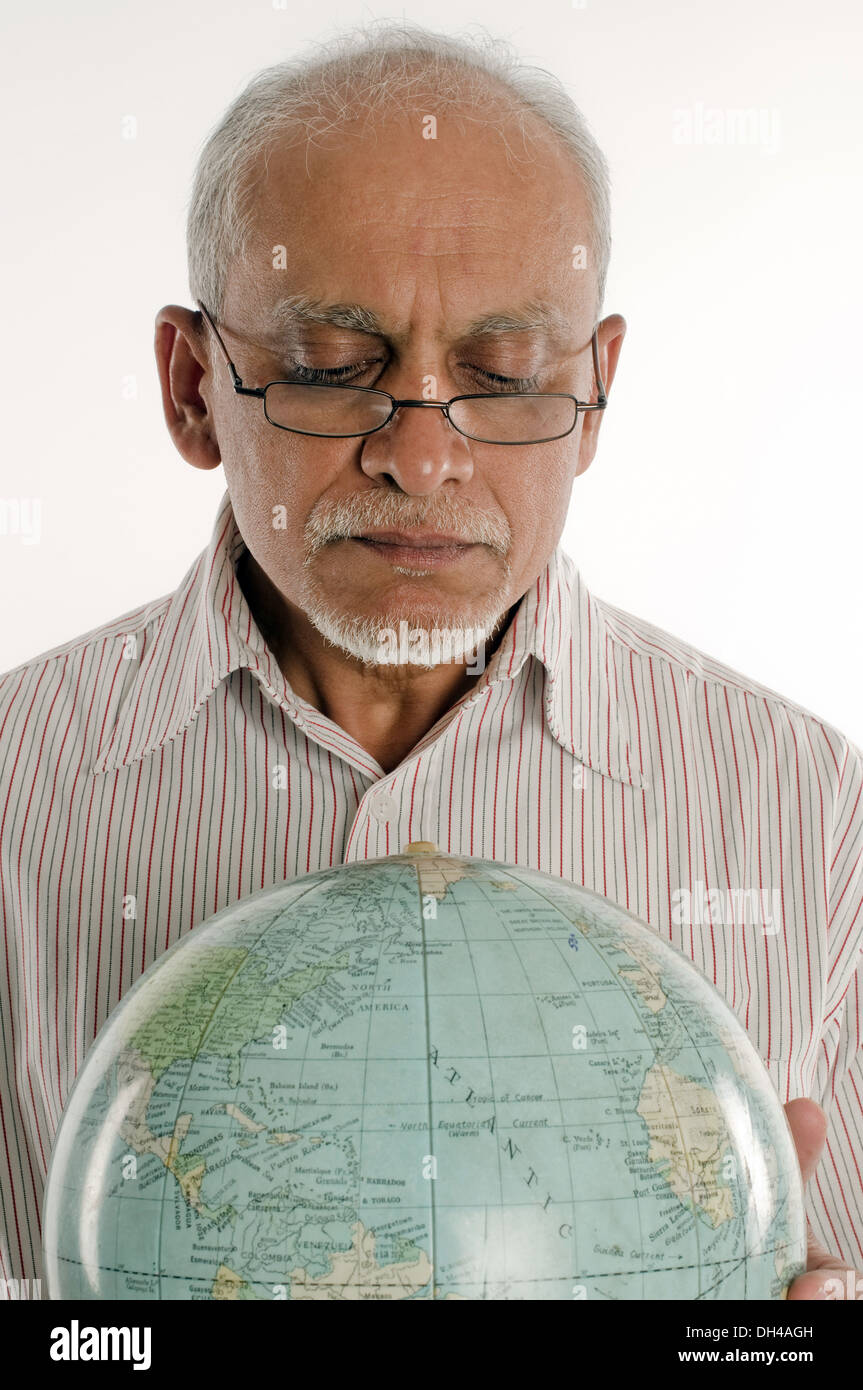 old man in glasses seeing globe Pune Maharashtra India Asia June 2012  MR#686P Stock Photo - Alamy