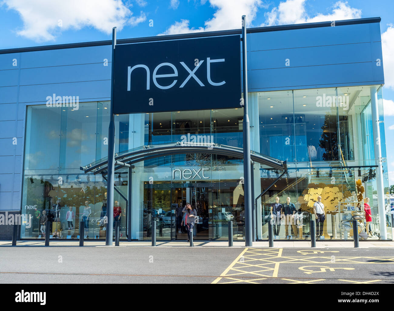 Newton Abbot,Devon,England. A young woman emerging from the Next store