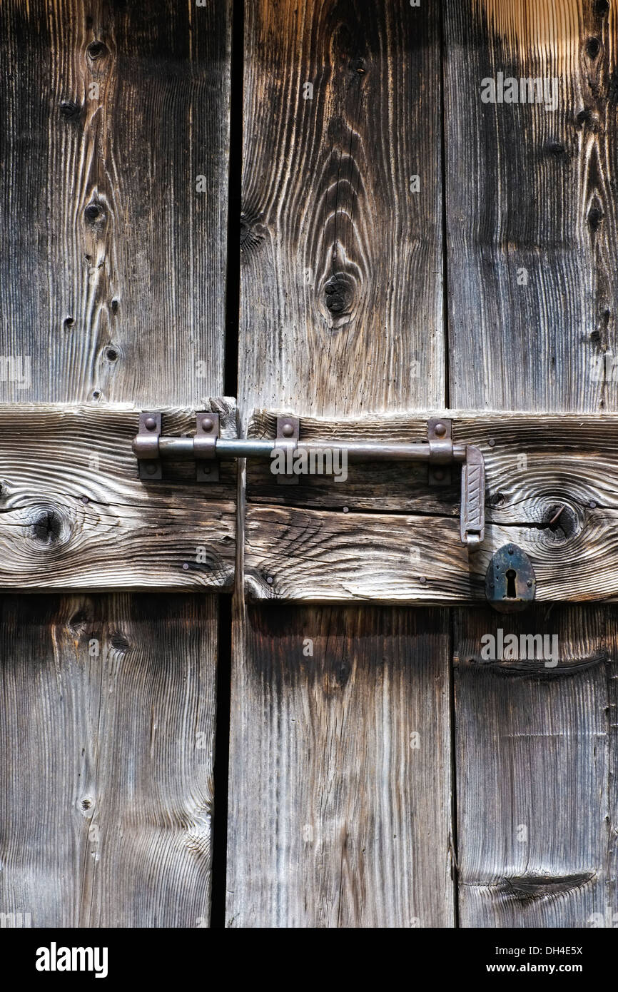 Old wooden door closed with latch Stock Photo