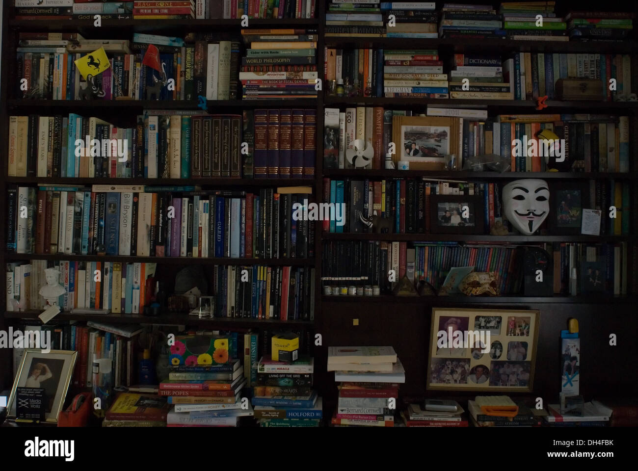 A bookshelf full of books and trinkets Stock Photo Alamy