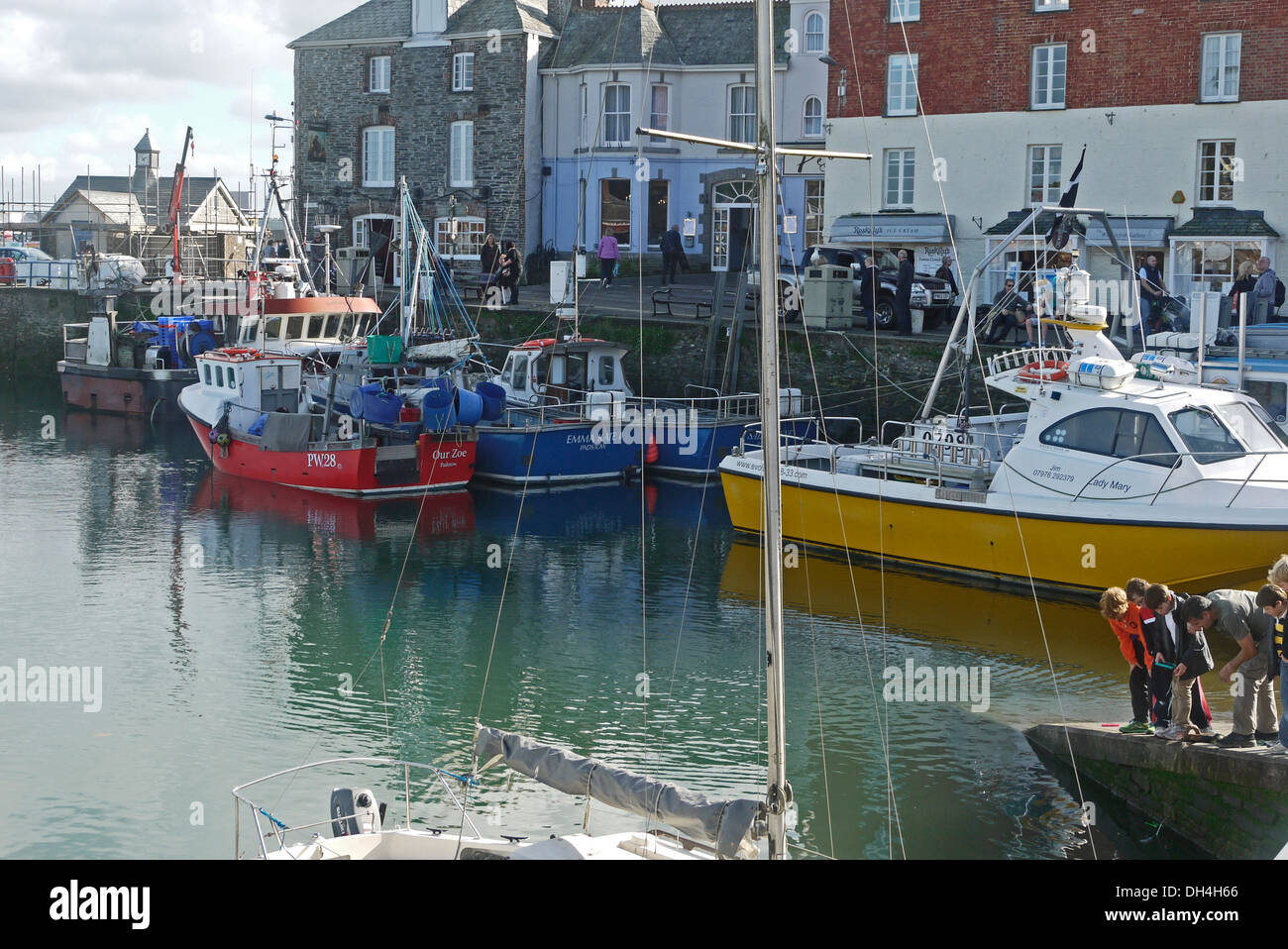 Padstow harbour, tourists crab fishing, Cornwall, England, UK Stock