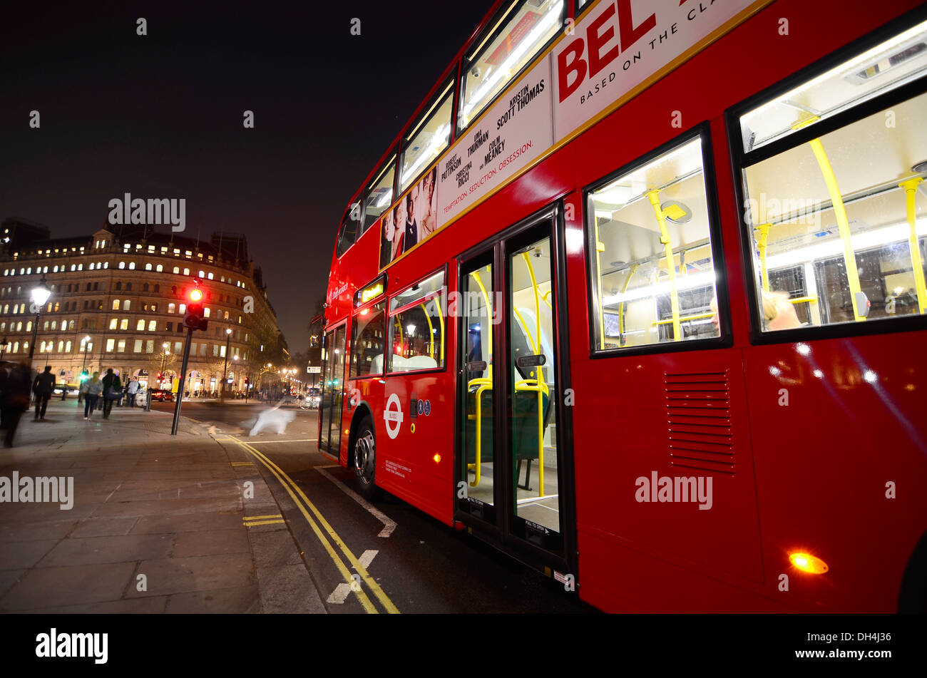 Red Double decker bus stopped at a traffic light in London Stock Photo