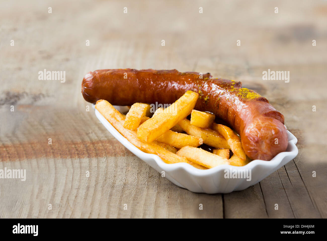 Popular German Fastfood (Saussage with Curry Sauce) Currywurst and French Fries isolated on