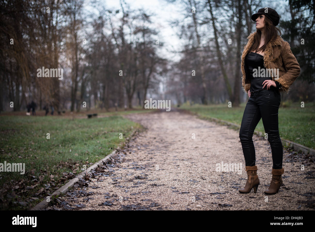 young woman in jacket standing and posing at the forest Stock Photo - Alamy