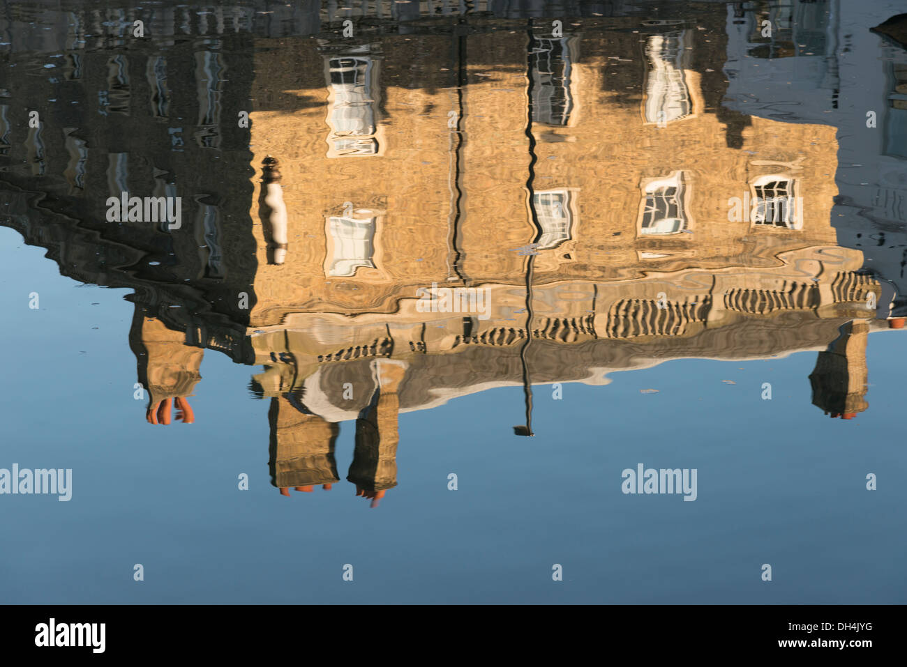 Queens College Cambridge reflected in the Millpond Cambridge UK in earl morning  autumn sunshine Stock Photo