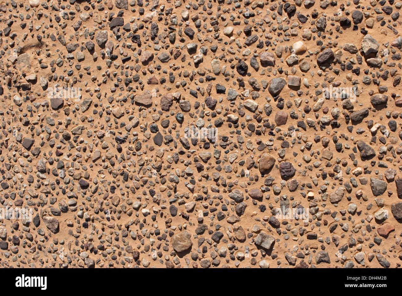 View down onto rock pebbles in desert sand Stock Photo