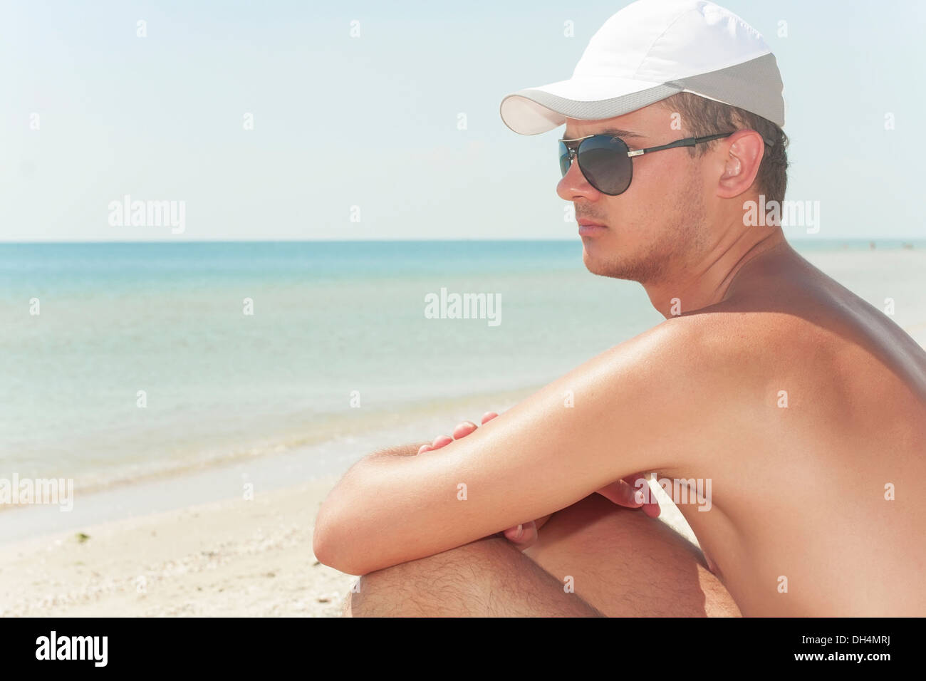 guy in wearing black glasses on a beach Stock Photo
