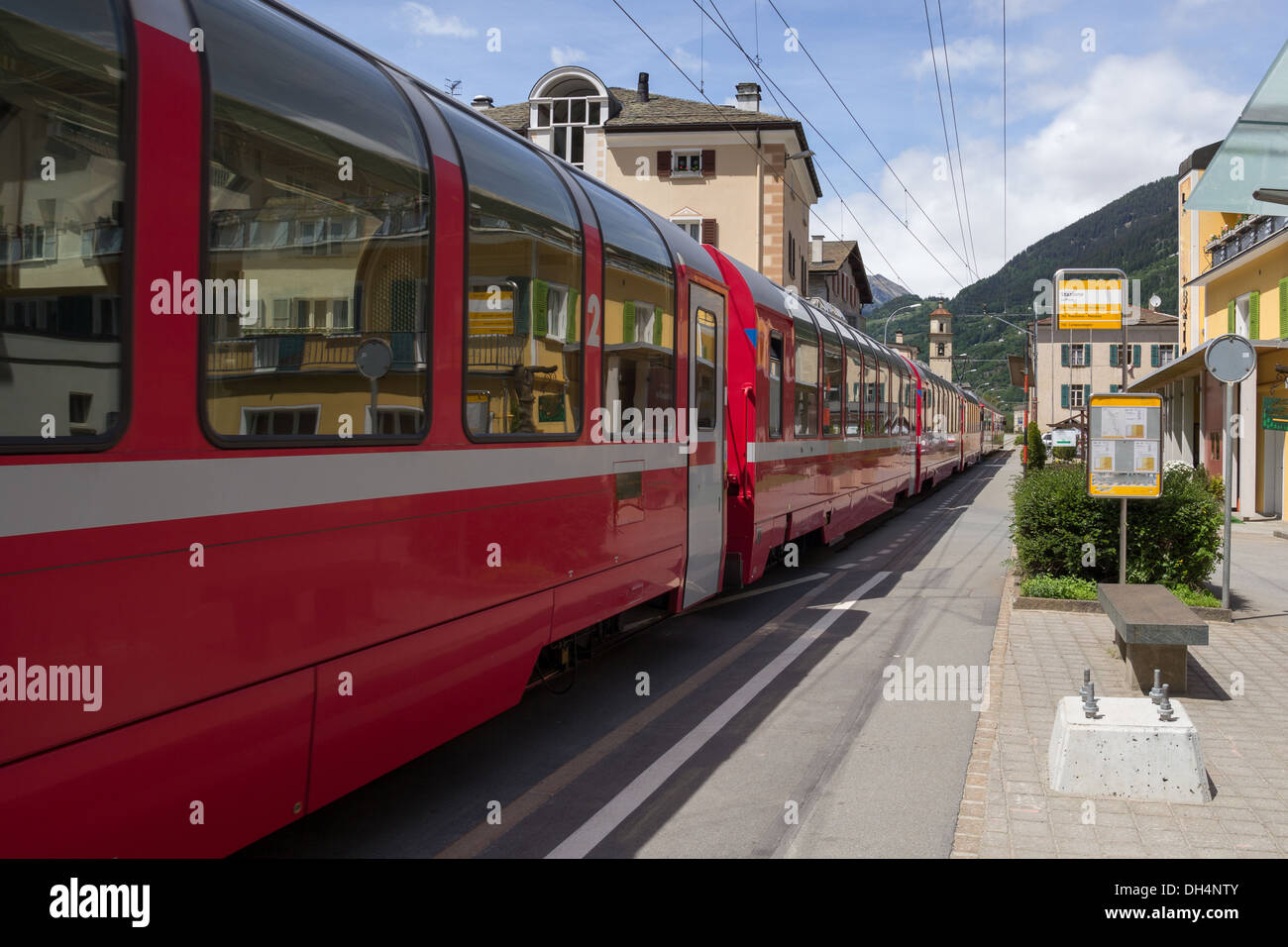 Swiss mountain train Bernina Express in small village La Prese Stock Photo