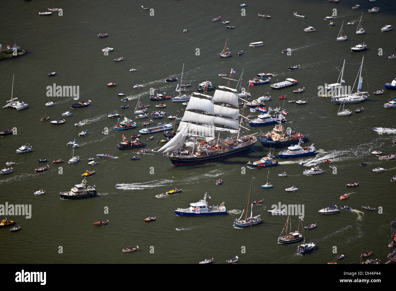 The Netherlands, Amsterdam, sailing event SAIL. Aerial of parade of tall ships. Big sailing boat called Clipper Stad Amsterdam. Noordzeekanaal. Stock Photo