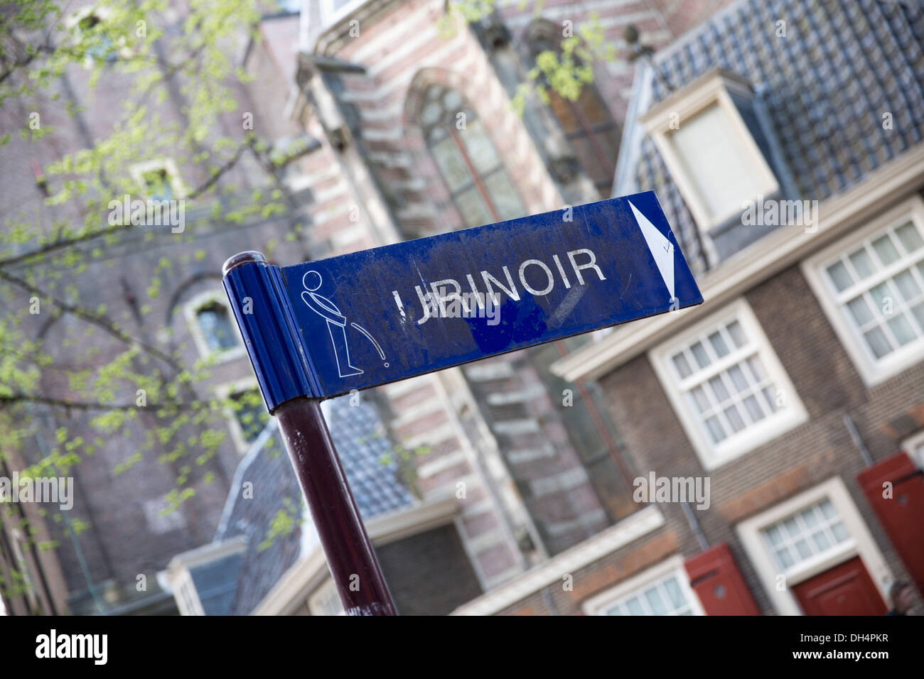 Netherlands, Amsterdam, Sign of urinal in the street near canal called Brouwersgracht. Unesco World Heritage Site. Stock Photo