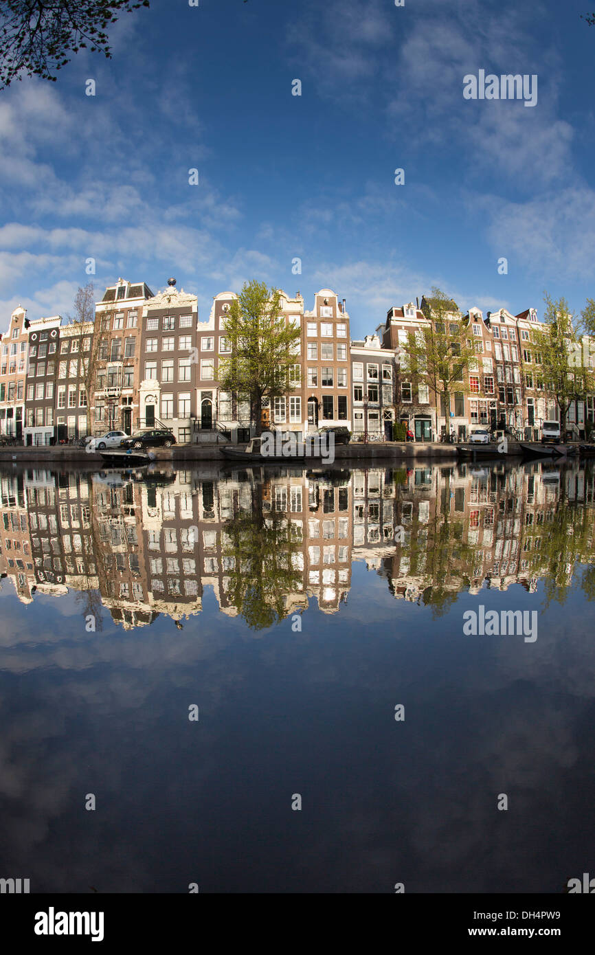 The Netherlands, Amsterdam, Reflection of Canalside houses and houseboats at canal called Singel. Unesco World Heritage Site. Stock Photo