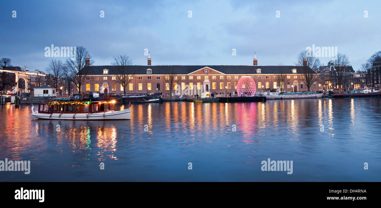 Netherlands, Amsterdam, The Hermitage Amsterdam museum along river Amstel Salonboat. Twilight Stock Photo