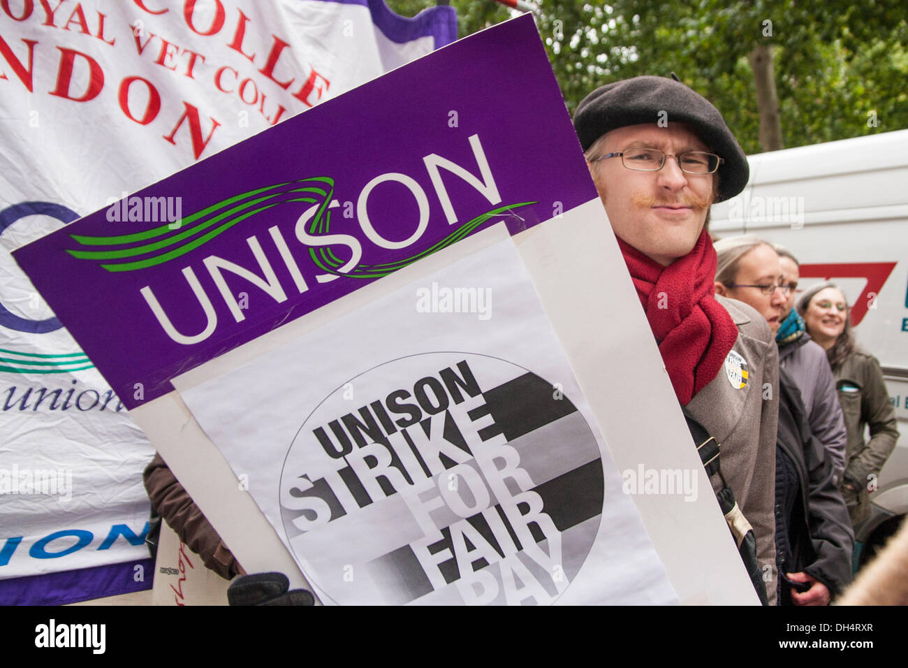 London, UK. 31st October 2013. A protester with his placard as striking staff, students and the unions Unison, Unite and UCU combined with pickets and a march to demand fairer wage increases and a living wage for low-paid university support staff. Credit:  Paul Davey/Alamy Live News Stock Photo