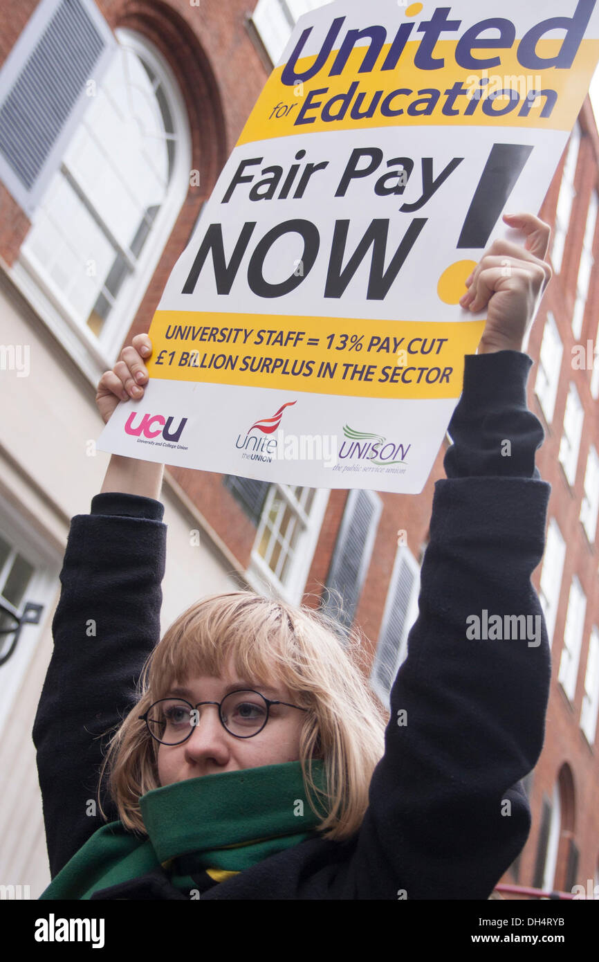 London, UK. 31st October 2013. A protester holds up her banner as striking lecturers, students, Unison, Unite and UCU combined with pickets and a march to demand fairer wage increases and a living wage for low-paid university support staff. Credit:  Paul Davey/Alamy Live News Stock Photo