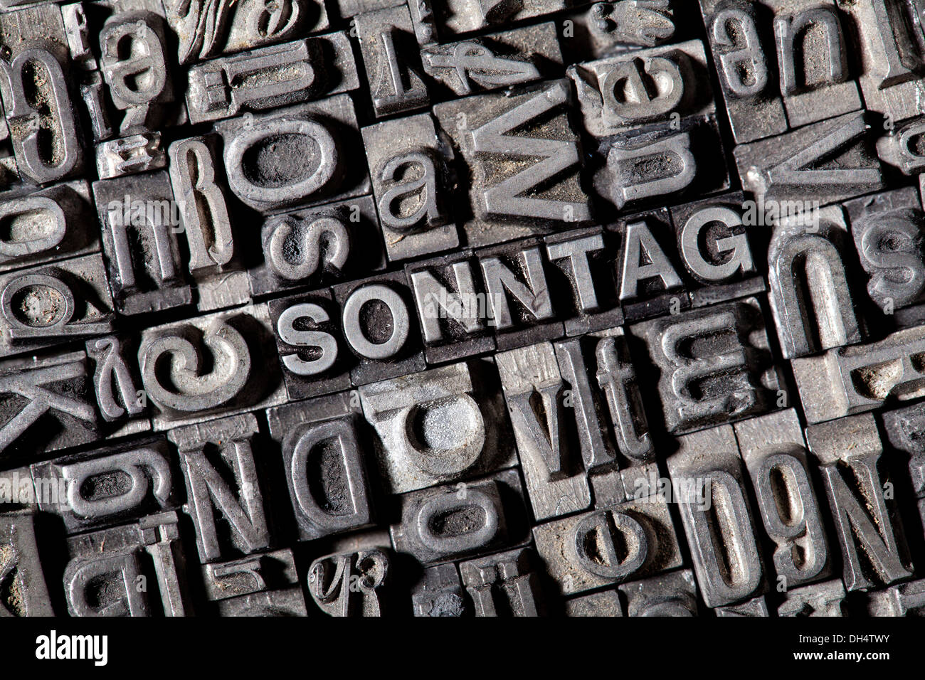 Old lead letters forming the word 'SONNTAG', German for 'Sunday' Stock Photo