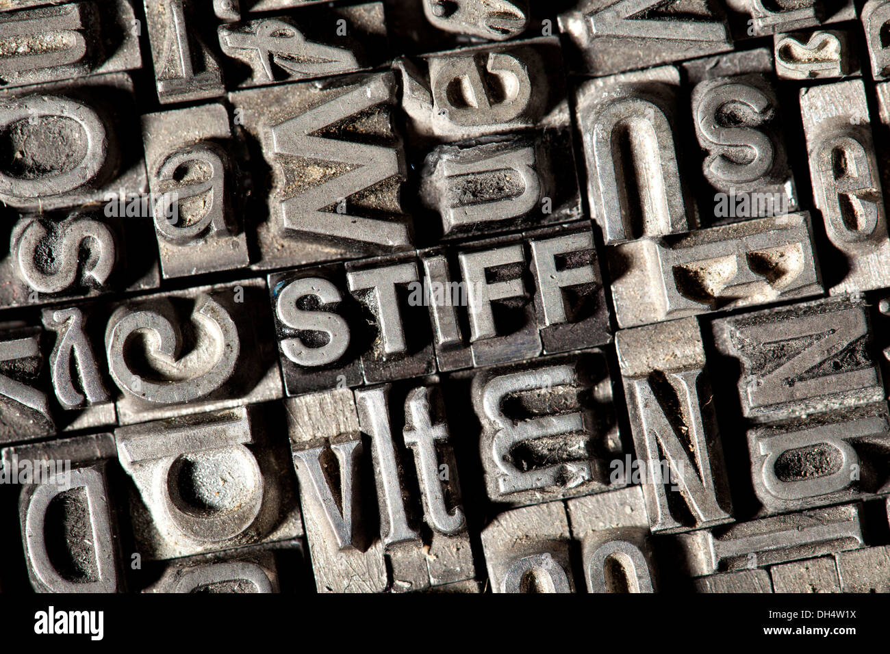 Old lead letters forming the word 'STIFF' Stock Photo