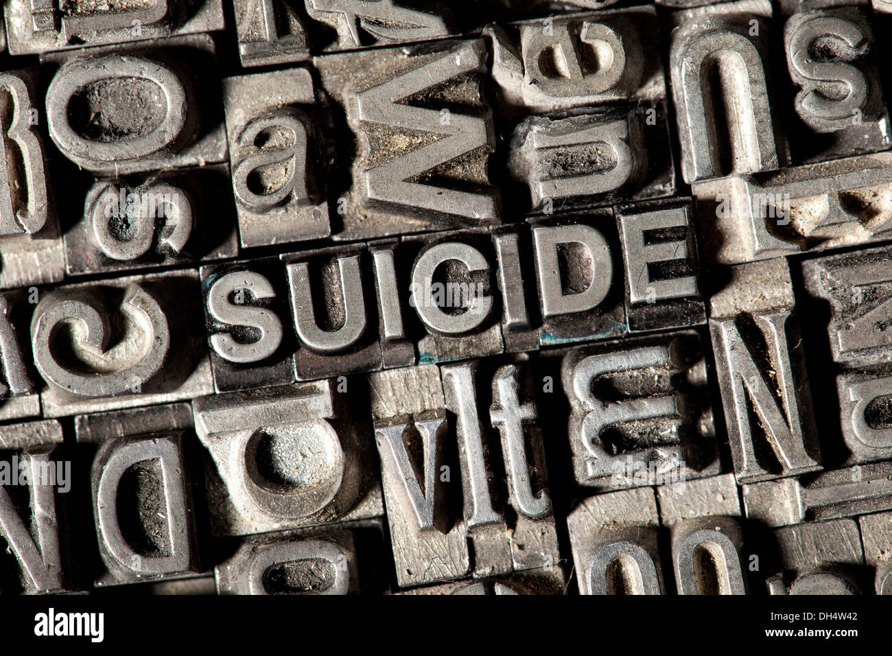 Old lead letters forming the word 'SUICIDE' Stock Photo