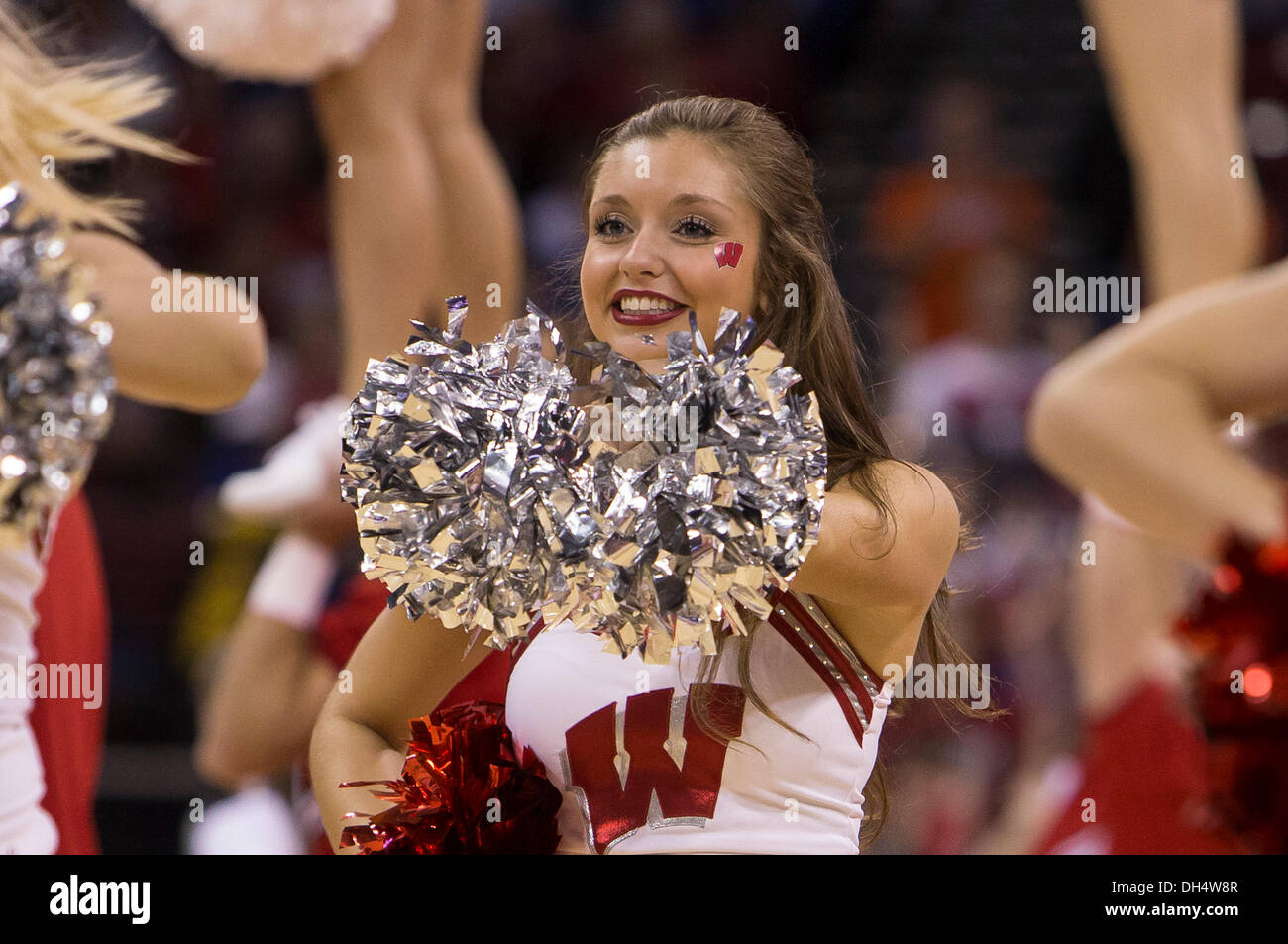 Madison, Wisconsin, USA. 30th Oct, 2013. October 30, 2013: Wisconsin Badgers cheerleader entertains the crowd during a timeout of the NCAA Exhibition Basketball game between UW-Platteville Pioneers and the Wisconsin Badgers. The Badgers defeated the Pioneers 80-51 at the Kohl Center in Madison, WI. John Fisher/CSM/Alamy Live News Stock Photo